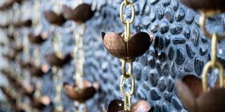 A close-up of decorative hanging elements made of metal with a textured background, showcasing a unique and artistic design.