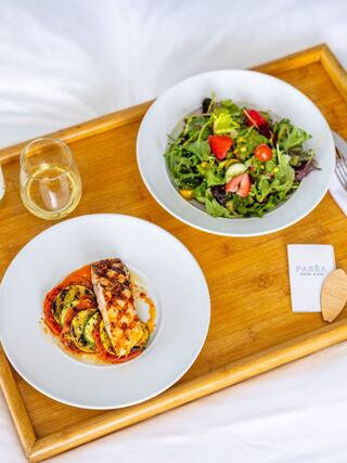 A cozy breakfast setting with plates of pancakes and fresh fruit, complemented by a refreshing drink and a bright, inviting atmosphere.