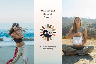 Two women engage in mindfulness and wellness activities beside the ocean, promoting a serene experience of movement, breath, and sound.